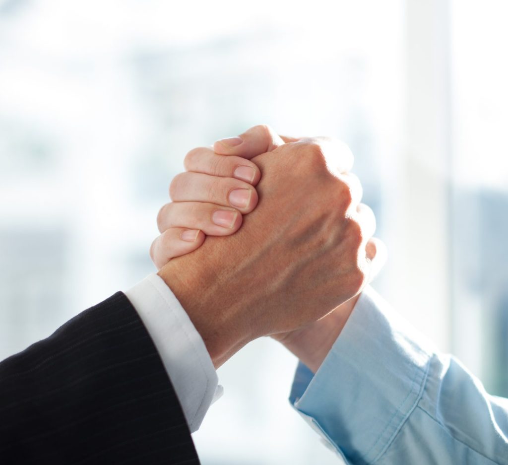 Close-up of two clasped hands of businessmen